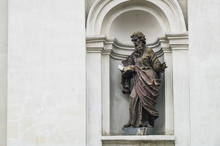 Ruined statue of Saint Paul on the facade of the Saint Peter and Paul Cathedral in Lutsk, Ukraineの写真素材