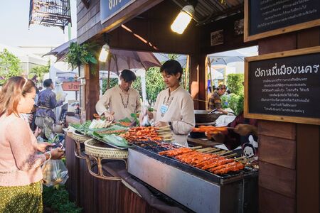 Bangkok, Thailand - March 2, 2018: Unidentified street vendor grilling pork for sale at the fair near the Royal Plaza and Sanam Suea Pa next to the plaza, Dusit district, Bangkok, Thailand.のeditorial素材