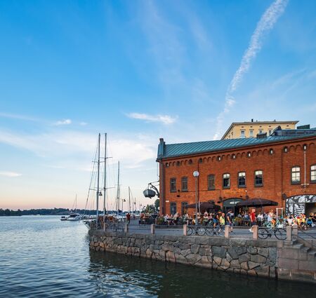 Helsinki, Finland - July 24, 2018: Embankment of Helsinki at summer evening, Finland. Town Quay in Katajanokka district is popular and famous tourist destination in Helsinkiのeditorial素材