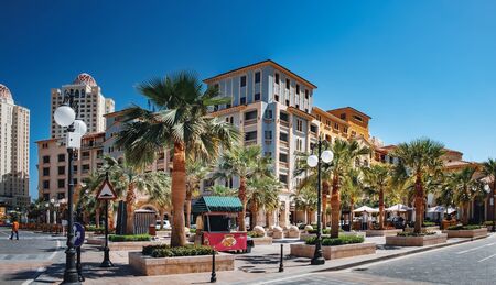 Doha, Qatar - March 3, 2018: Panoramic view of central district with street cafe near the Pearl...
