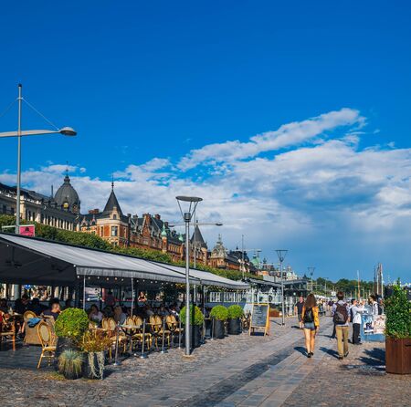 Stockholm, Sweden - August 5, 2018: Strandvagen embankment with outdoor cafe and walking people, Ostermalm district in central Stockholm, Swedenのeditorial素材