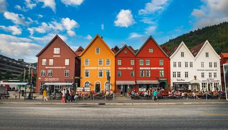 Bergen, Norway - August 1, 2018: Tourists visiting and enjoying the Old Town pier architecture in...