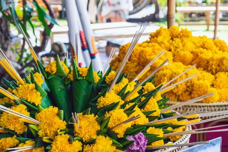 Marigold flowers garland and decorations to sold in the morning market of Thailand. Faith and believe in concept.の写真素材
