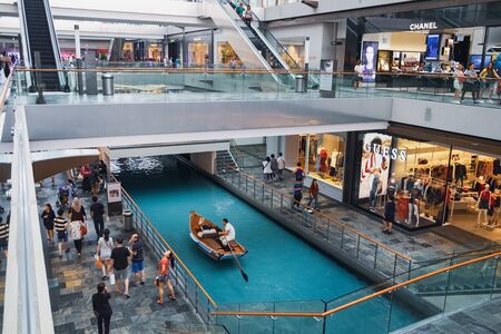 Singapore - January 17, 2018: Water canal and boat at The Shoppes at Marina Bay Sands which runs through the length of the Shoppes. It is a popular tourist destination in Singaporeのeditorial素材