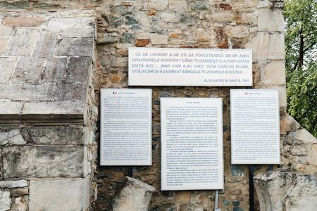 Targu Neamt, Romania - September 5, 2017: The brief history for tourists in English, Romanian and French is on the castle wall of Neamt Citadel, near Targu Neamt, Romania.のeditorial素材