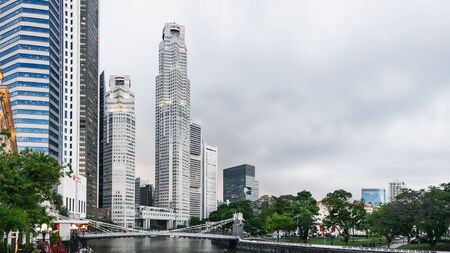 Singapore - January 17, 2018: Sunset view of the downtown core of Singapore in Central Business District and Cavenagh Bridge over Singapore River.のeditorial素材