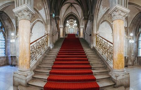 Vienna, Austria - August 20, 2019: Panoramic view of beautiful staircase with red carpet in Town Hall or Rathaus, Vienna, Austria.のeditorial素材