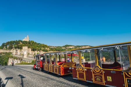 Veliko Tarnovo, Bulgaria - September 10, 2017: Sightseeing train rides on the old street leading to the Patriarchal Cathedral on the top of Tsarevets hill in Veliko Tarnovo, Bulgariaのeditorial素材