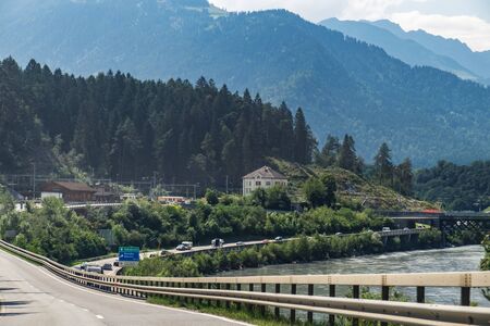 Reichenau village and Alpine Rhine in Domat Ems municipality, Switzerland. The name of the city on street signsの写真素材