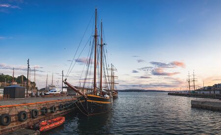 Old Town pier with old boats and sailing ship. Historical district of the Aker Brygge in Oslo, Norway.の写真素材