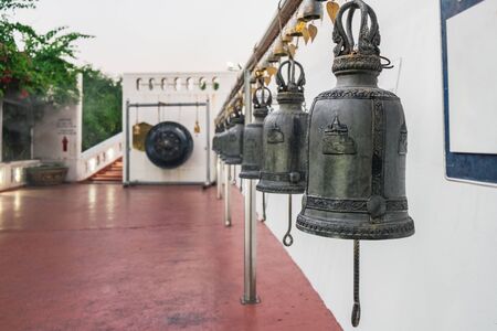 Row of Thai style bells in buddhist temple. Golden Mount temple, Bangkok, Thailand.の写真素材