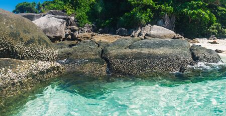Sunny day with blue sky and turquoise water at tropical rocky beach, Similan Islands, Thailand