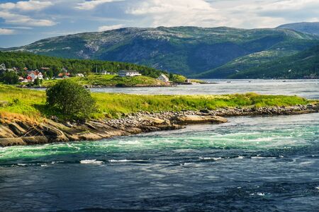 Norwegian summer landscape, stream view with whirlpools and waves near Saltstraumen bridge, Bodo, Nordland, Norwayの写真素材