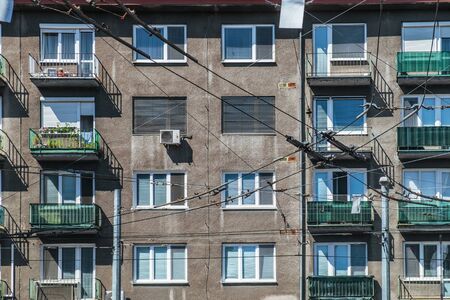 Windows in panel tower house, facade of building with balconies. Typical old socialist block of apartment in Bratislava city, Slovakiaの写真素材