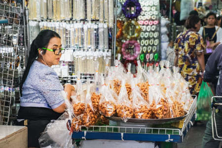 Bangkok, Thailand - March 2, 2018: Unidentified street vendor of sweet crispy balls dessert in Chinatown. Yaowarat is a street food market in Bangkok.のeditorial素材