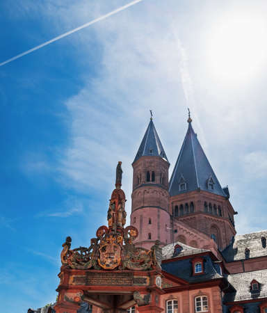 Mainz, Germany - August 12, 2018: Silhouette of German red church bell tower with antique statues, Mainz Cathedral under blue cloudy sky, located in Old Town of Mainz, Germanyのeditorial素材