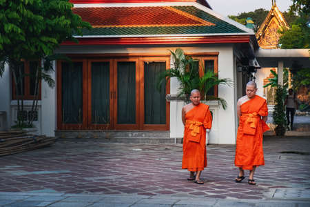 Bangkok, Thailand - February 28, 2018: Thai monks walking near famous Wat Pho public ancient Temple...