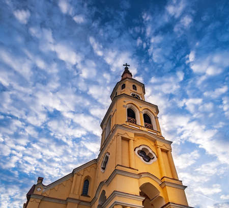 Holy Trinity Evangelical Church in Zvolen town, Slovakia. Panoramic scenic bottom view of old Lutheran church in main square of Zvolen, near Zvolen Castle under blue cloudy sky. Slovak architectureの写真素材