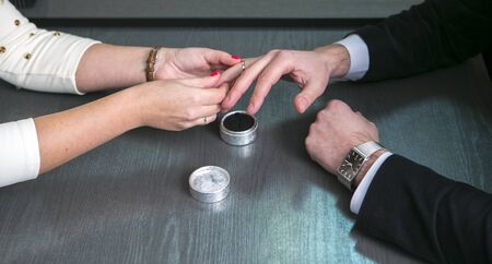 The bride wears a wedding ring on the fingerの写真素材