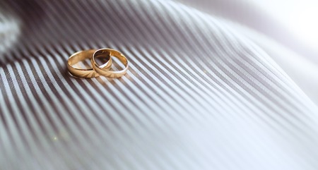 Wedding rings on fabric in stripesの写真素材