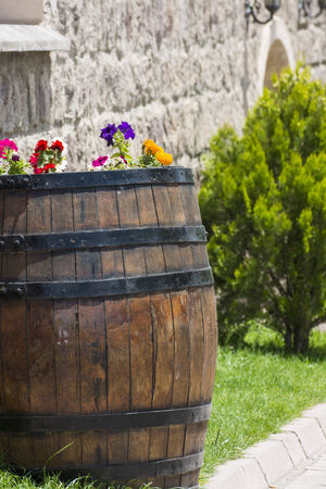 Summer flowers in a wooden barrel.の写真素材