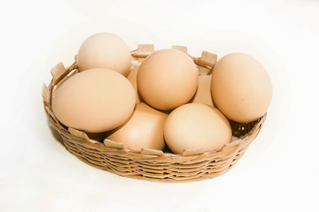 Brown eggs in basket isolated on white backgroundの写真素材