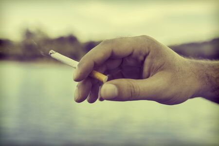 man smoking a cigaretteの写真素材