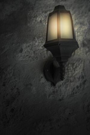 lamp on brick wall at night