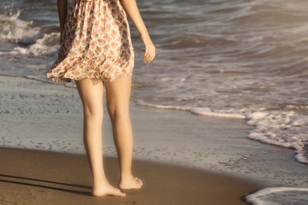 The legs of a woman walking on a beachの写真素材