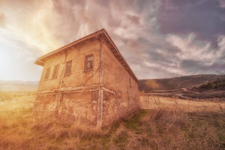 Rural landscape with old house in sunshineの写真素材