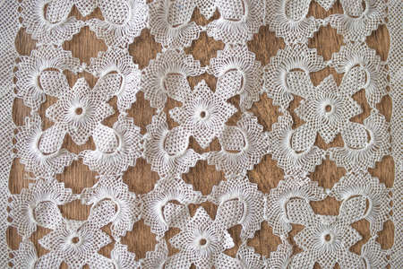 pattern of  lace fabric against wooden background