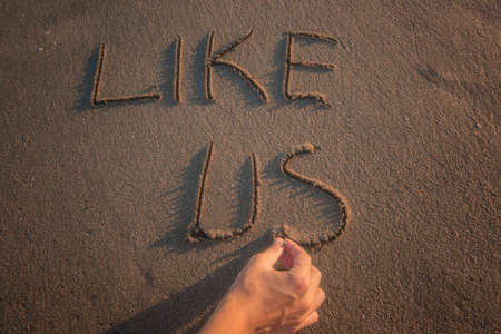 Like - text written by hand in sand on a beach,の写真素材