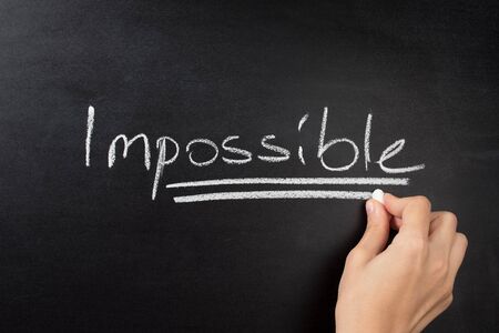 impossible text on blackboardの写真素材