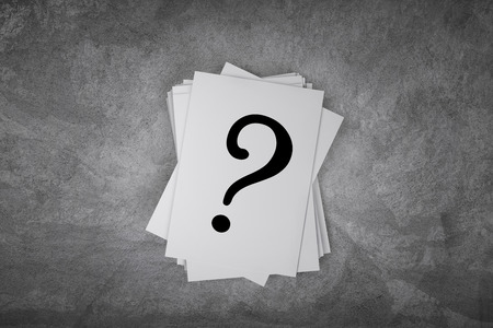 Paper card on a concrete table with question mark sign with free spaceの写真素材