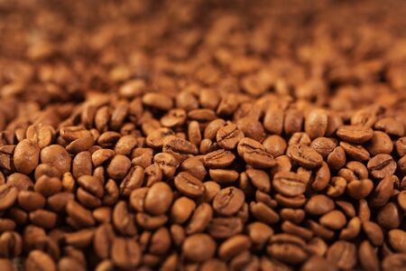 Roasted coffee beans background, close up