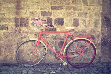 Old retro bicycle against brick wallの写真素材