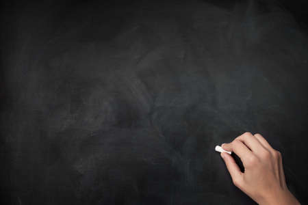 hand with chalk, starting to writeの写真素材