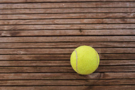 Tennis ball on wooden backgroundの写真素材