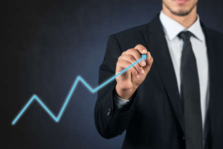 businessman hand drawing virtual chart business on touch screen computerの写真素材