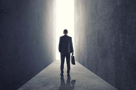 Silhouette of businessman entering giant doorwayの写真素材