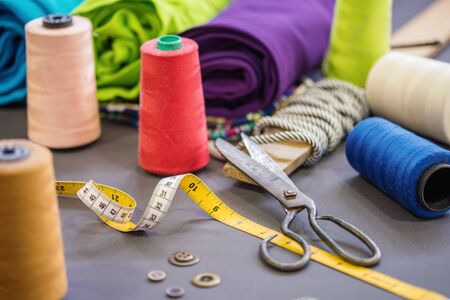 Sewing accessories on fabric background.Textile concept.