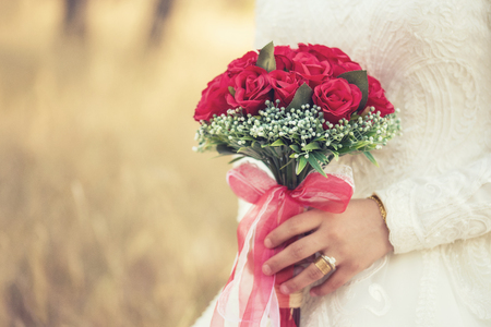beautiful tender wedding bouquet in hands of the brideの写真素材