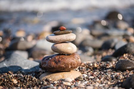 Stack of pebble stones on white background.の写真素材
