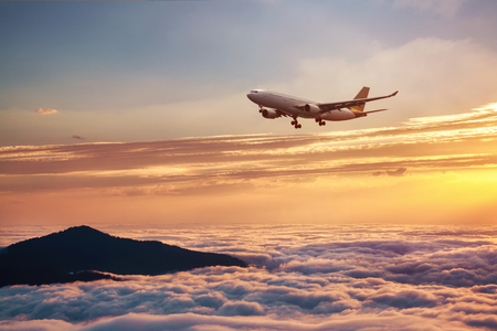 Airplane in the sky at sunset - Passenger Airliner aircraft.の写真素材