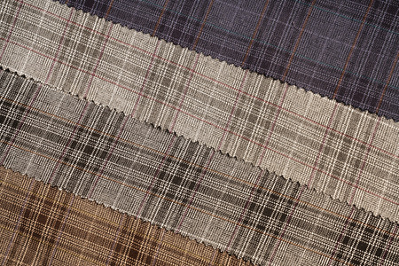 Tartan plaid natural cotton fabric. Seamless tiles texture for the background.