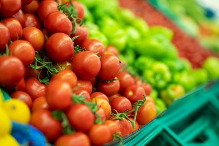 Fresh tomato and peppers in grocery markets full of vegetables.の写真素材
