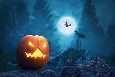 Spooky pumpkin lantern in the scary graveyard for Halloween.の写真素材