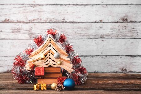 Christmas decoration with ornaments and christmas tree from books.の写真素材