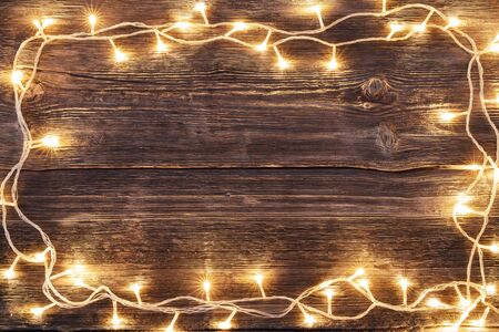 Vintage Christmas wooden background with led lights border