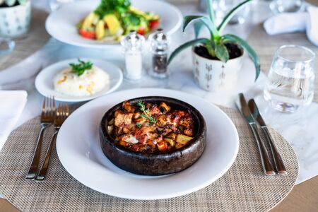 A delicious spicy chicken casserole with rice is served in a elegance restaurant or hotel.